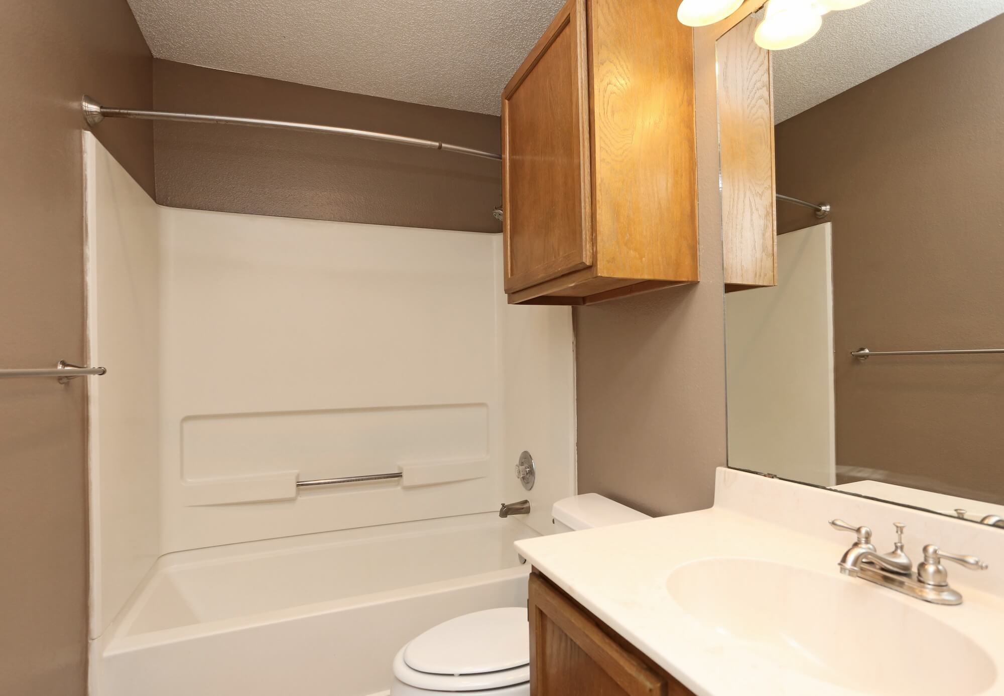 Full bathroom with shower, tub, toilet, and sink.