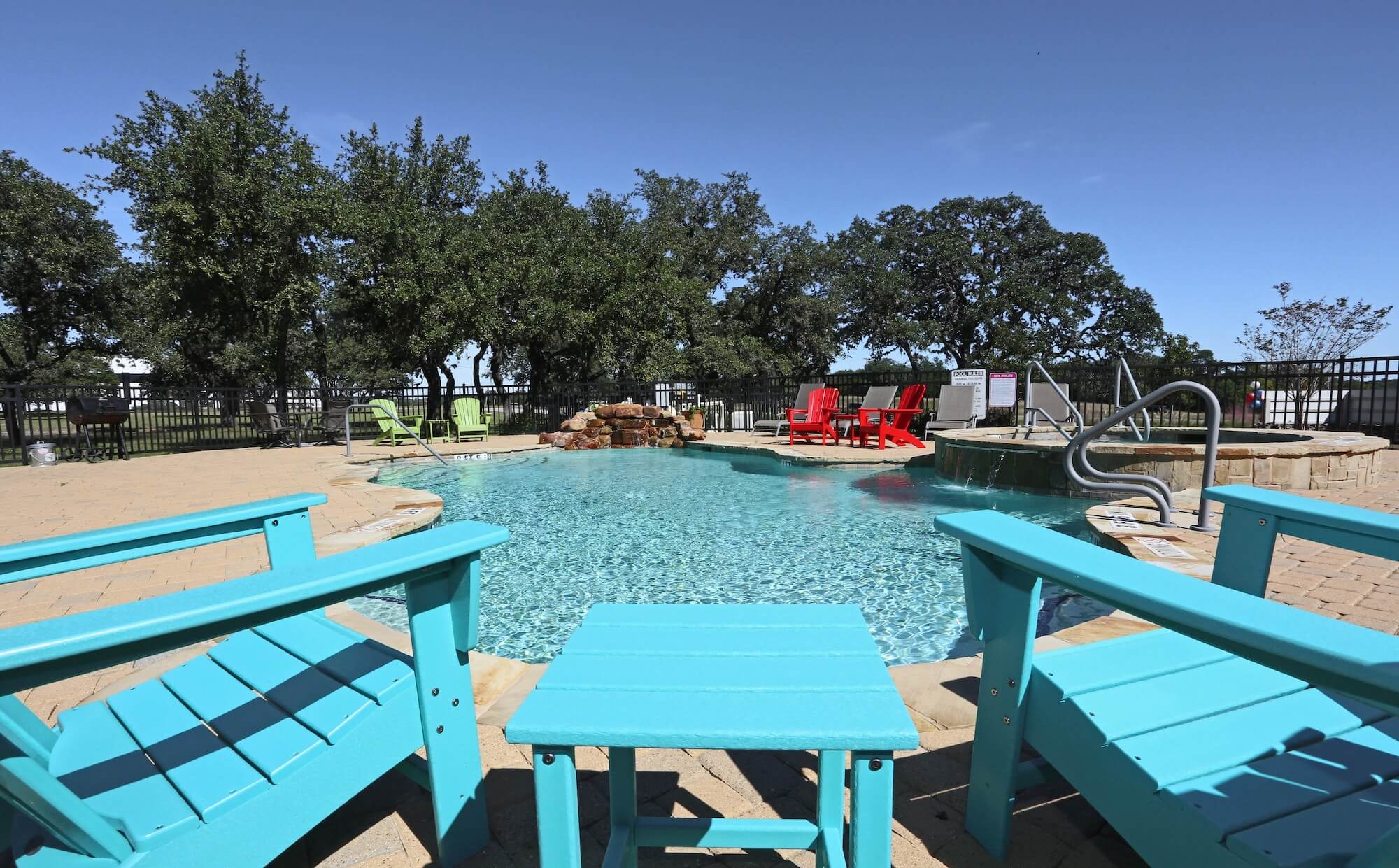 Pool with two blue chairs ready to lounge in