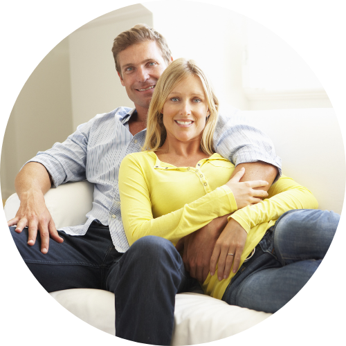 Couple lounging on a couch in their apartment.